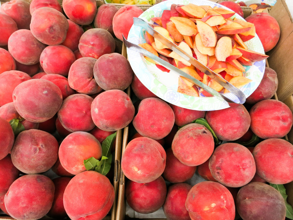 Local Californian peaches at San Francisco's Ferry Building Farmers Market. They have half a dozen different varieties and you can sample before buying. YES PLEASE!
